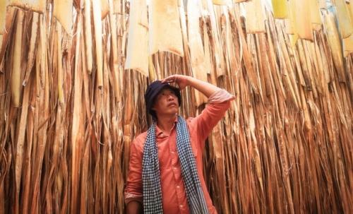 Nhan is pictured with the medium for his artworks - melaleuca bark. Photo courtesy of Le Hoang Nhan